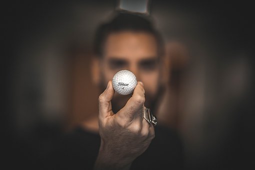 man holding a golf-ball